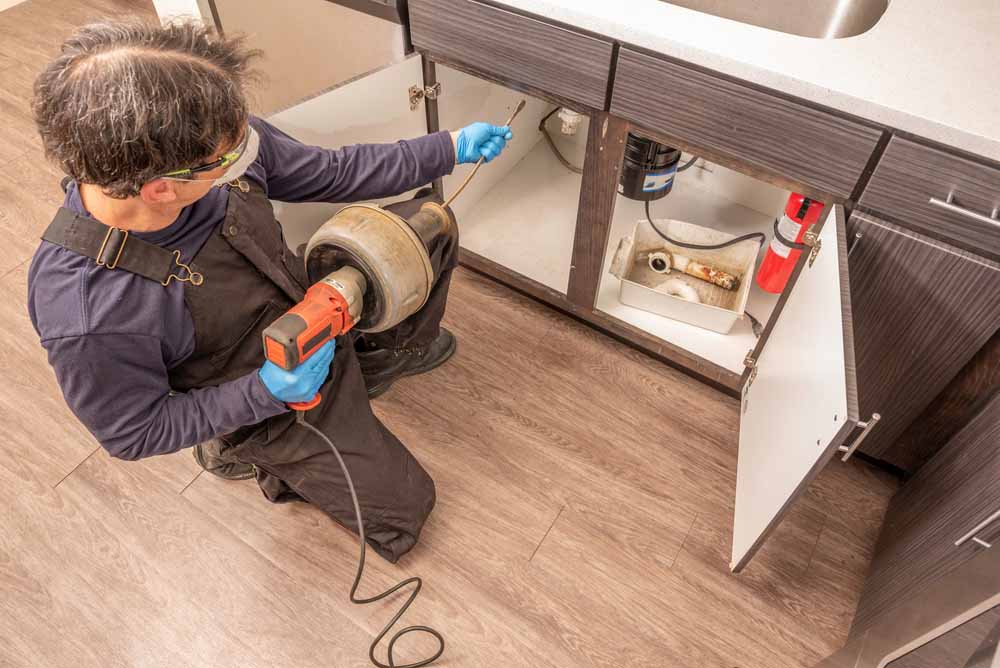 Plumber snaking a drain Plumber snaking a drain